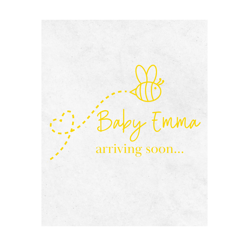 White wine label with yellow text 'Baby Emma arriving soon...' and a bee illustration is shown on a white background