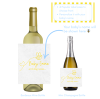 Two wine bottles with personalized labels for a baby shower, one for Bordeaux wine and one for mini champagne.