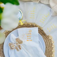 Napkins with 'A little honey is on the way' text on a decorative table setting. Matching frost flex cups are also shown.