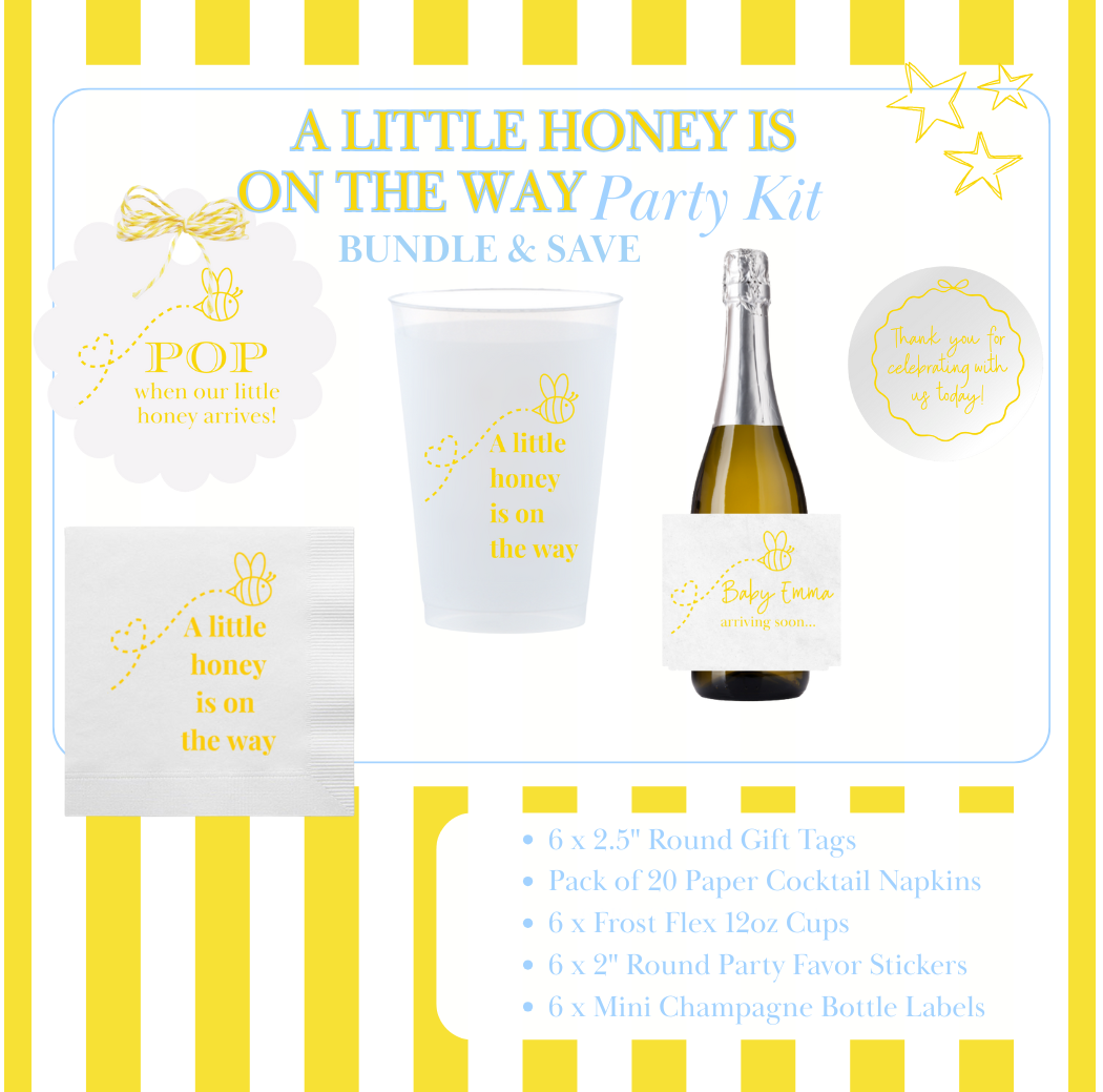 Bee-themed Baby shower party kit with champagne bottle, cups, gift tags, and decorative items on a yellow and white striped background.