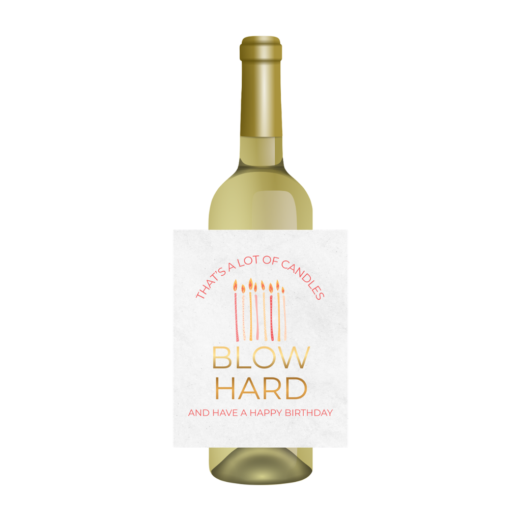 Wine bottle with a humorous birthday message on the label against a white background. The label shows birthday candles and text that reads "That's a lot of candles - BLOW HARD - and have a happy birthday."