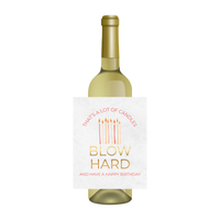 Wine bottle with a humorous birthday message on the label against a white background. The label shows birthday candles and text that reads "That's a lot of candles - BLOW HARD - and have a happy birthday."