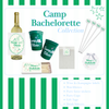 Collection of 'Camp Bachelorette' themed party supplies including wine labels, cups, and stirsticks on a green and white striped background.