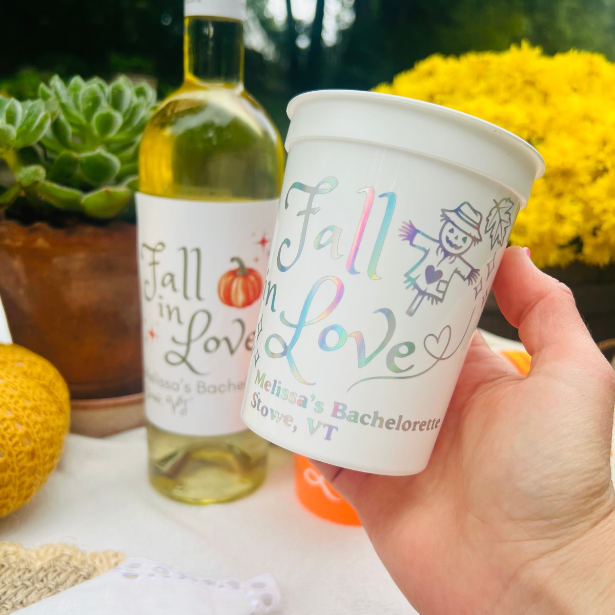 Fall In Love White Bachelorette Cup Held near a fall decorated table