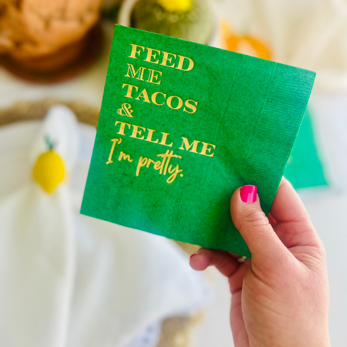 Green napkin with 'Feed me tacos & tell me I'm pretty' text held by a hand. Perfect for final fiesta bachelorettes, Taco Tuesday parties, Cinco De Mayo and more. 