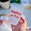 Clear 16oz frost flex cup with red text 'festive as f*ck' held by a hand, with decorative items in the background.
