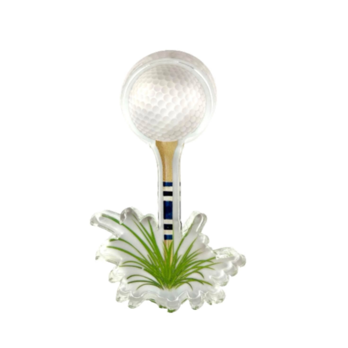 Clear lucite napkin weight in the theme of a golf ball on a tee in a tuft of grass against a white background