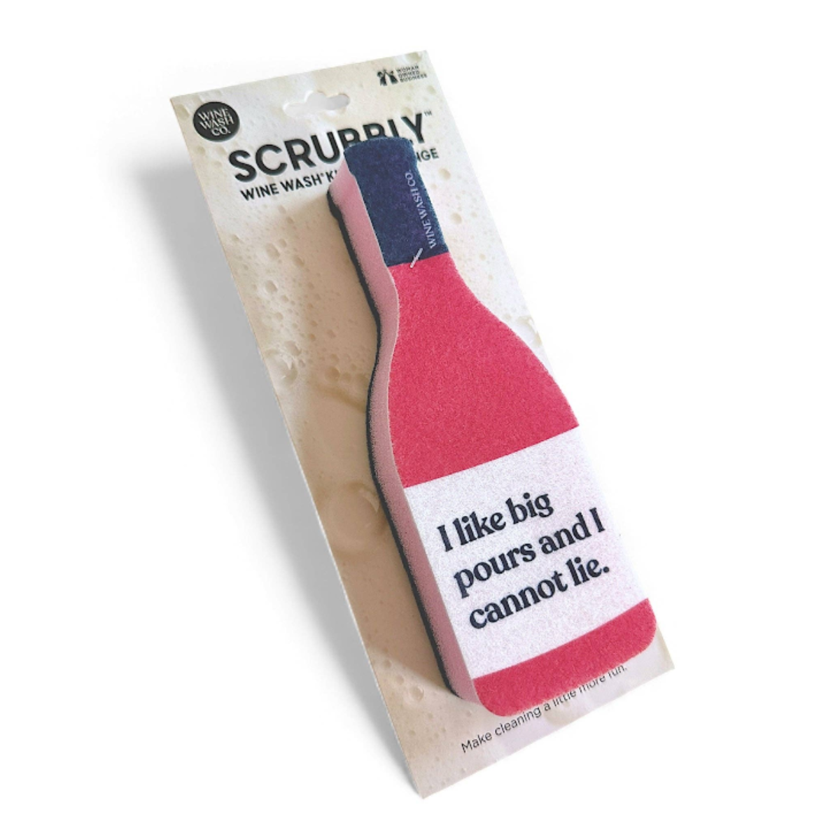 Scrubbly wine wash sponge in a bottle-shaped design, attached to its retail backing card. The sponge features a red body, a white label with the text 'I like big pours and I cannot lie.