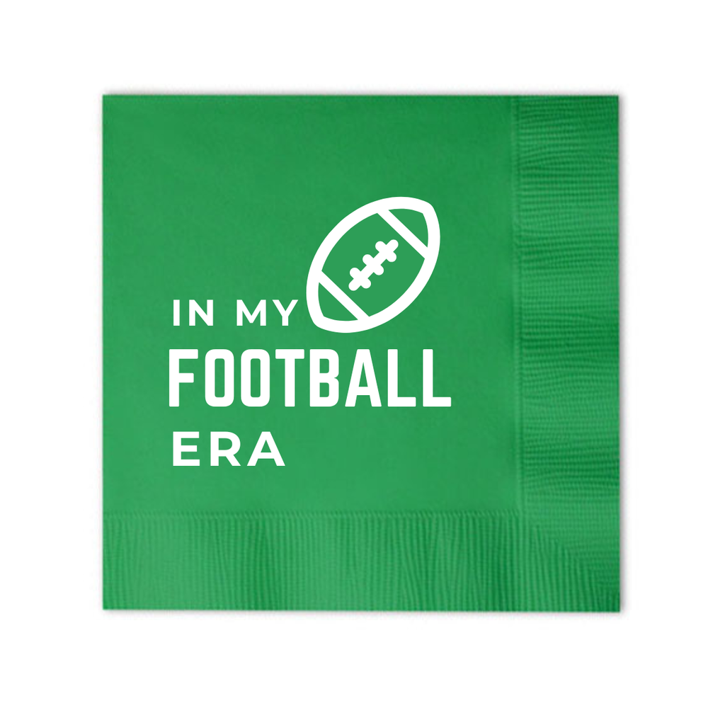 Green napkin with white text and football graphic on a white background. The text reads "In My Football Era" for football watch parties, Super Bowl celebrations, and tailgating.