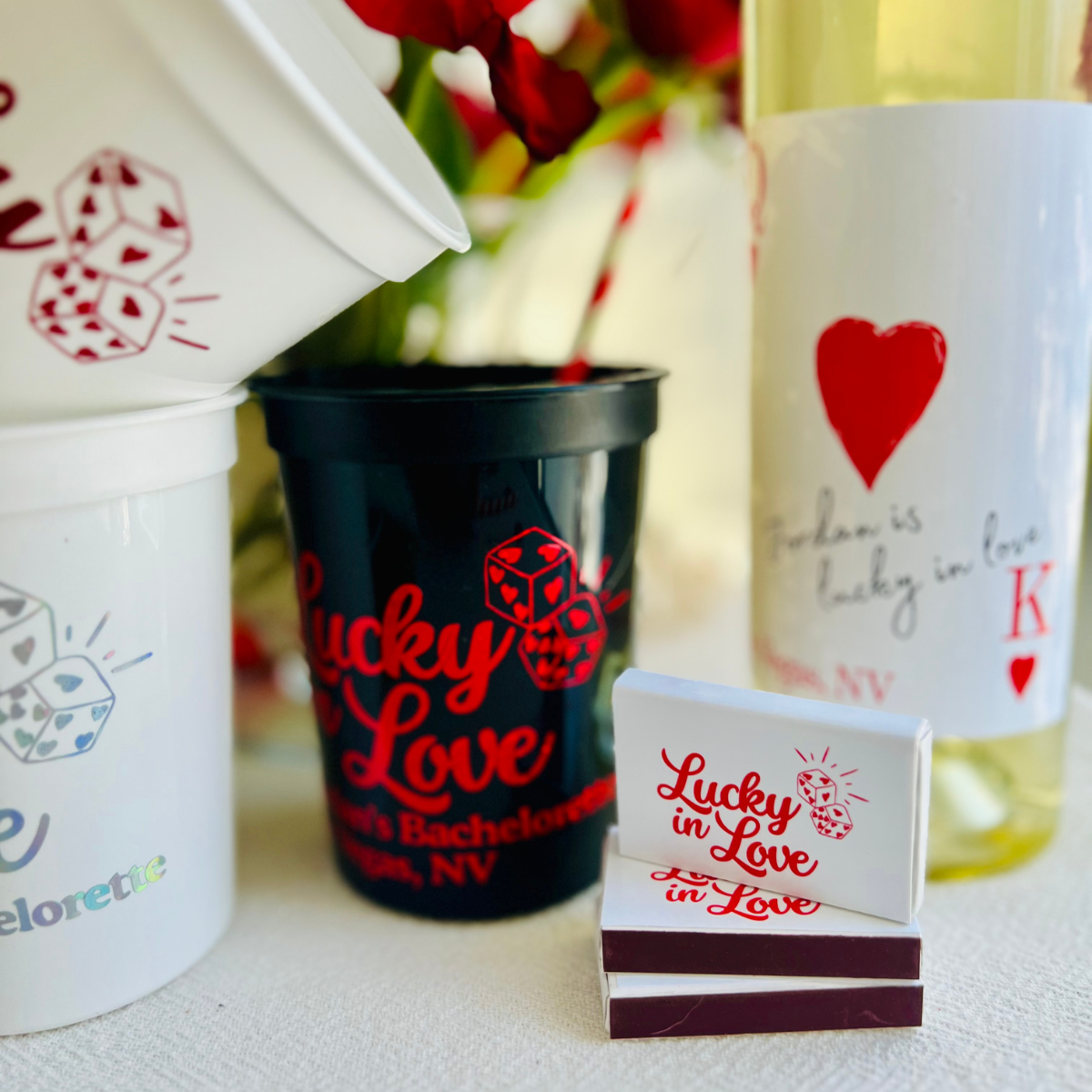 Stadium cups and a stack of matchboxes is shown with a matching "Lucky in love" design