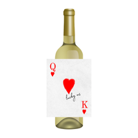 Wine bottle with a unique label featuring playing card symbols and text that reads "lucky us" against a white background
