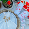 Image of can coolers and mini liquor bottles along with matching matchboxes are shown on an outdoor table. 