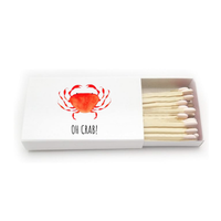 Matchbox with red crab design and 'OH CRAB!' text on a white background