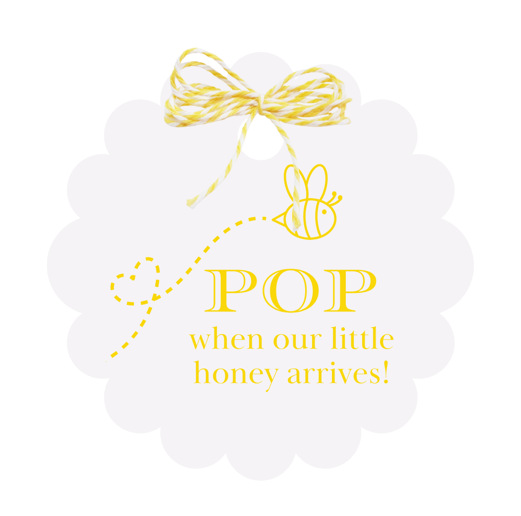 White gift tag with yellow and white bakers twine is featured against a white background. The gift tag has the image of a bee flying above text that reads "Pop when our little honey arrives!"