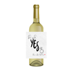 White wine bottle with a customizable engagement wine label that says 'She said Yes' on a white  background. Add the label to a bottle of wine or a champagne bottle for a novel engagement gift for the bride and groom-to-be.