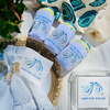 Bridal shower favor with 'Shuck Yeah' design on a decorative background