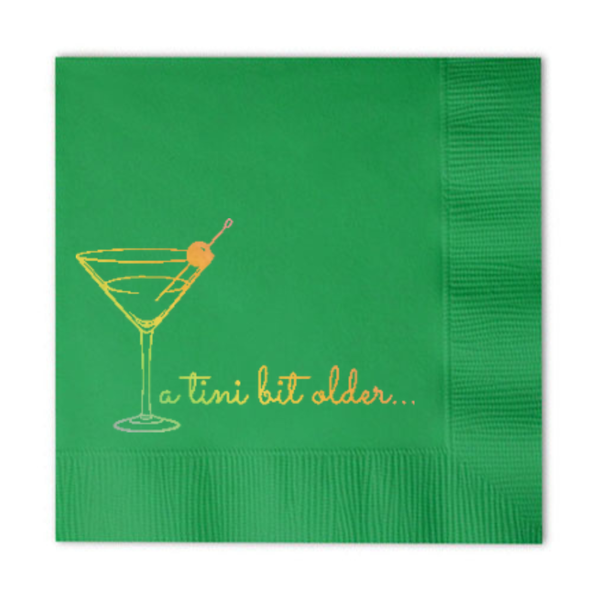 Green paper cocktail napkin featuring a holographic gold design that has a martini glass and the phrase "a tini bit older. 