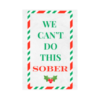 Close-up of a funny holiday wine label that features the text "We Can't  Do This Sober" in a candy-striped  frame. 