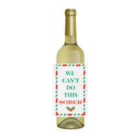 White bottle with a fun holiday wine label that reads "WE CAN'T DO THIS SOBER" wine label. Perfect for holiday gifting and hosting. 