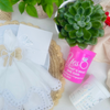 Pink cup with 'Yes, That's What She Said' text, white and green succulent on a light surface.